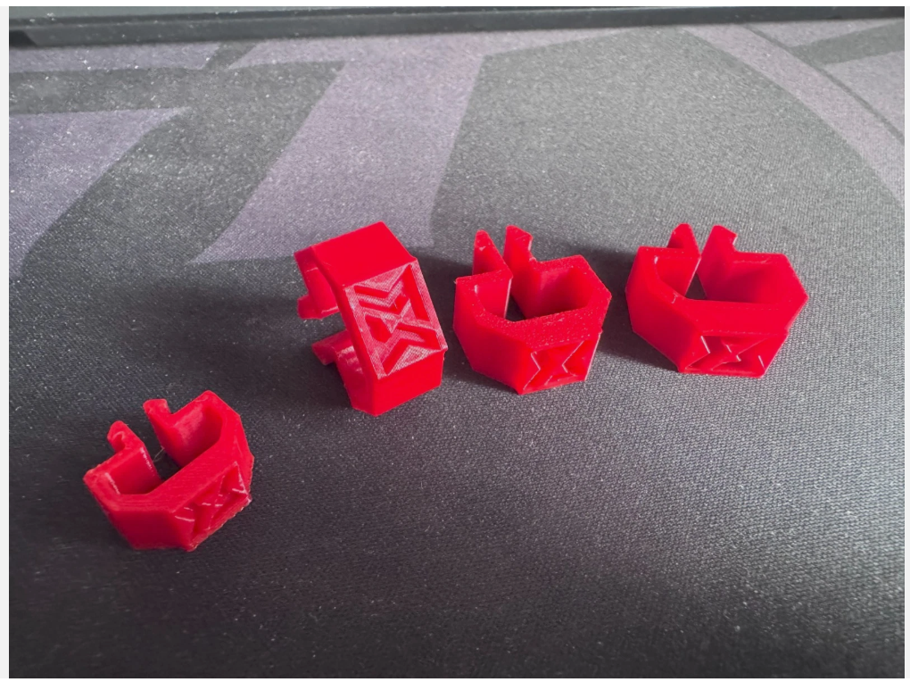 Four red Widdowmaker cable clips